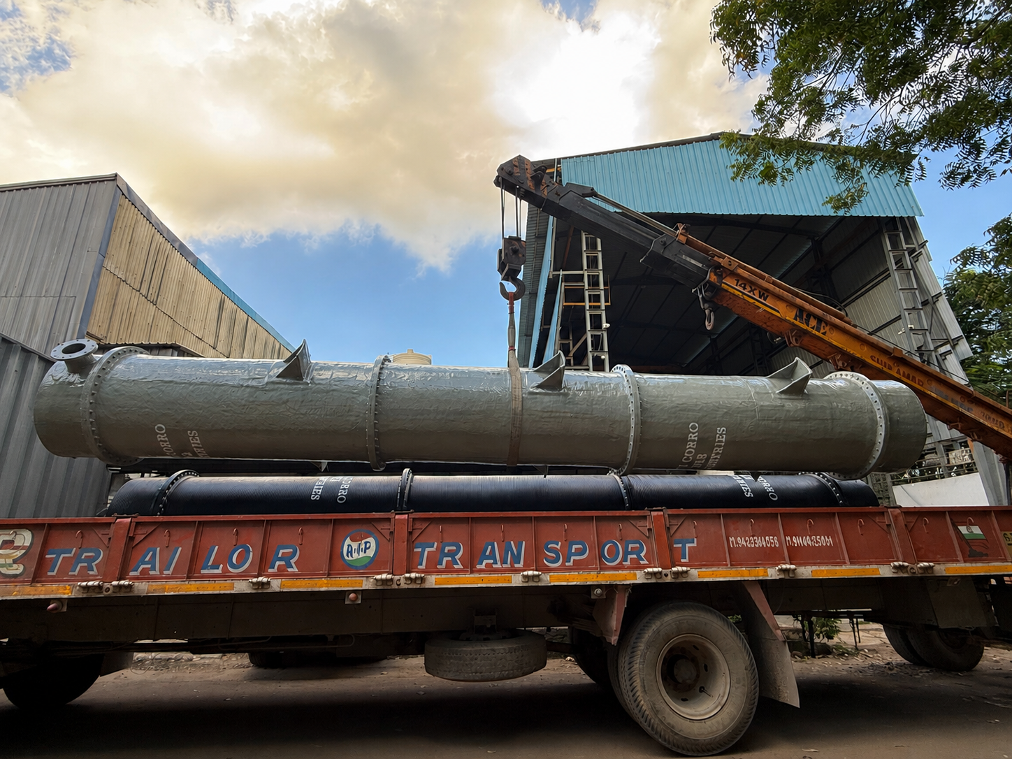 Overhead crane lifting fabricated vessel at ACFI facility